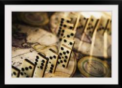 Row of dominoes on old world map