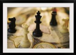 Chess pieces on old world map